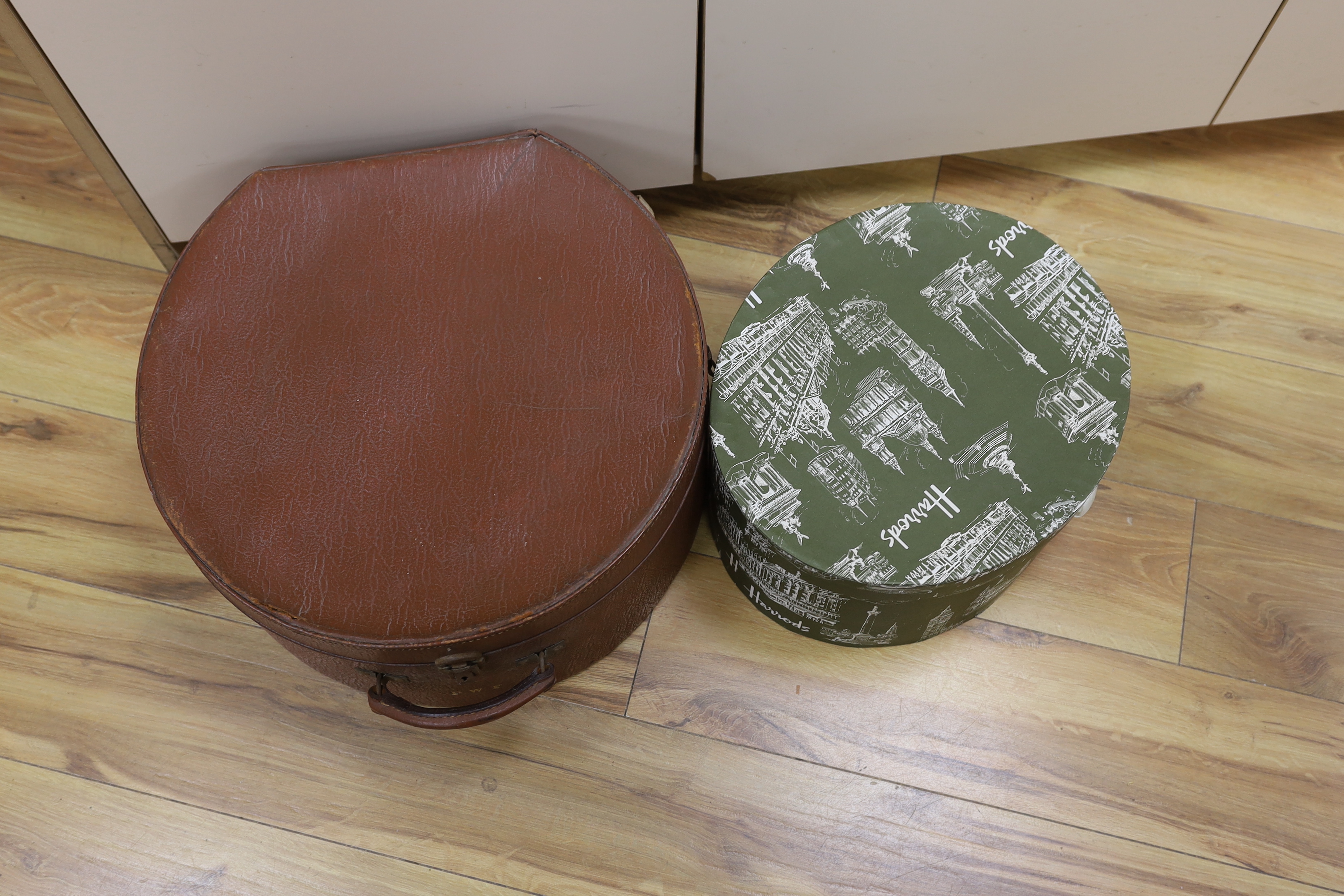 A circular Harrods branded hat box and a larger gents brown leather hat box, Harrods box 36cm diameter